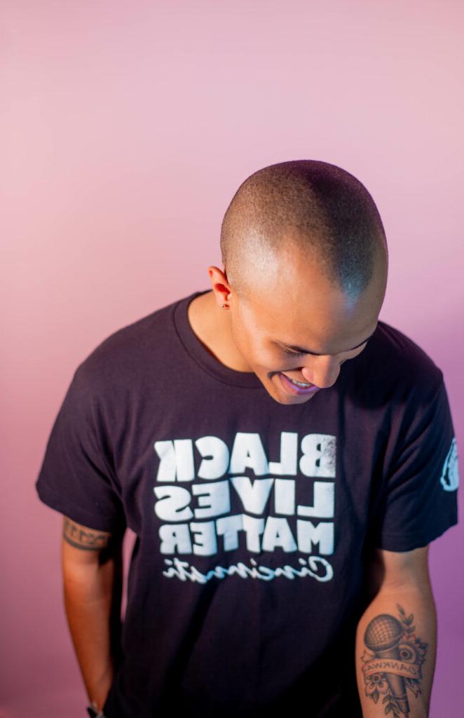 man laughing looking down with black lives matter shirt on